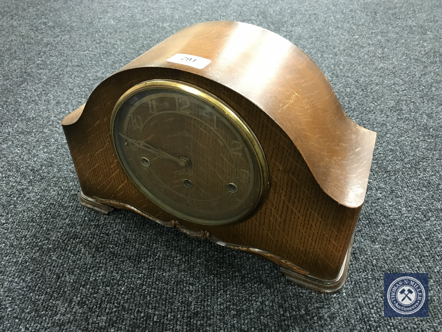 An oak cased Smiths Enfield mantel clock with pendulum and key