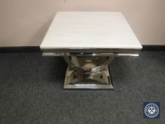 A contemporary polished steel lamp table with white polished stone top,