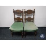 A pair of early 20th century carved oak bedroom chairs