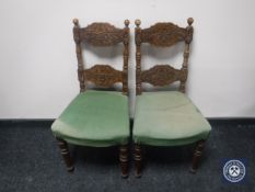 A pair of early 20th century carved oak bedroom chairs