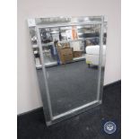 An all glass framed sectional mirror