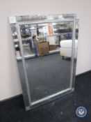An all glass framed sectional mirror