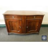 An antique mahogany serpentine fronted sideboard