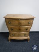 An antique pine shaped fronted three drawer chest