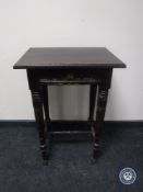 An antique oak occasional table fitted a drawer