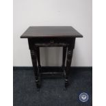 An antique oak occasional table fitted a drawer