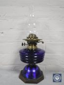 A 20th century oil lamp with glass chimney and blue glass reservoir