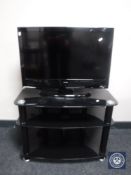 An Alba 26" LCD TV DVD with remote on stand