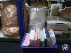 Three plastic storage boxes together with two bags containing assorted bedding