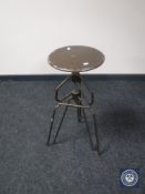A machinist's industrial metal adjustable stool