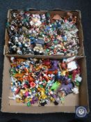 Two boxes of plastic Disney toys and tourist figures