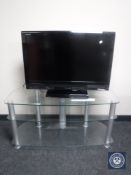 A Toshiba Regza 32" LCD TV with remote on stand