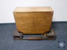 An early 20th oak extending fire curb and a walnut drop leaf table