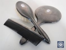 A silver-backed mirror and hand brush together with a silver comb