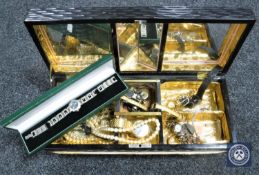 An oriental style musical jewellery box containing a collection of assorted wristwatches and