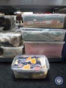 Six plastic storage crates containing assorted bedding, towels,