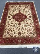 A Kashan carpet on beige ground,