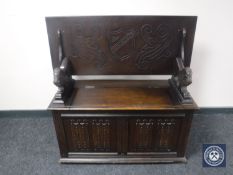 An oak linen fold monk's bench