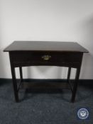 An Edwardian oak hall table fitted a drawer
