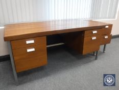 A mid 20th century teak twin pedestal writing desk and two drawer office chest