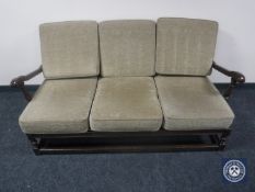 A wood framed Ercol three-piece lounge suite
