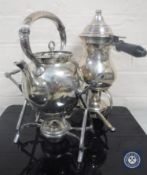 Two plated spirit kettles on stands with burners