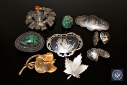 A collection of silver jewellery including brooches,