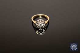 An 18ct gold diamond cluster ring, the central stone estimated at 0.