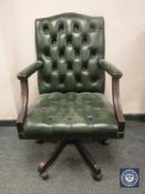 A green buttoned leather Chesterfield style swivel high backed desk chair, width 61 cm.