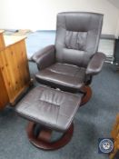 A brown leather electric swivel armchair with stool