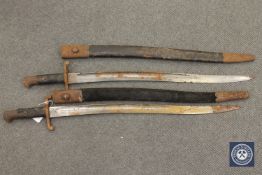 Two British Enfield sword bayonets in leather scabbards (2)