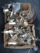 Two boxes containing brass chandeliers and wall lights,