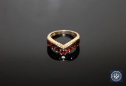 A 9ct gold garnet wishbone ring, size O CONDITION REPORT: 5.