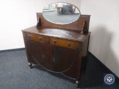 A 20th century oak mirror backed sideboard