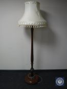 A 20th century mahogany standard lamp and shade