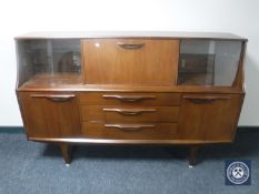 A mid 20th century teak cocktail sideboard