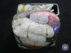 A plastic crate and a bag containing a quantity of wool