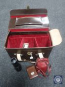 A vintage leather camera bag containing a Photax Bakelite camera, lenses and accessories,