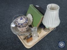 A tray of assorted boxed cutlery, metal and china table lamp with shade,