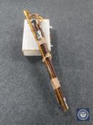 A bundle of assorted walking sticks and shooting stick,