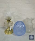 A Victorian brass and glass oil lamp with chimney and shade together with two further glass shades