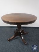 A mahogany circular pedestal breakfast table