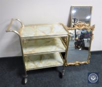 A three tier tea trolley together with two gilt framed mirrors