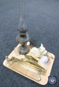 A tray of vintage copper oil lamp with chimney, pot metal figure of a terrier, brass flute,