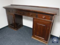 An early 20th century twin pedestal clerk's desk fitted five drawers