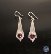 A pair of silver and cabochon garnet earrings