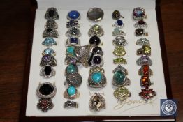 A ring box containing a collection of forty-six silver dress rings,