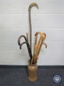 A West German vase containing assorted walking sticks and shepherd's crook,