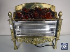 A brass electric fire with glass coals