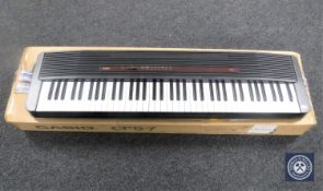 A Casio CPS-7 electric keyboard on stand with box